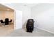 Bedroom showcasing light grey walls, carpet, massage chair, and a glimpse of dining area at 5233 Nw 43Rd Lane Rd, Ocala, FL 34482