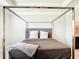 Neutral bedroom with a cozy canopy bed featuring carpet floors at 5233 Nw 43Rd Lane Rd, Ocala, FL 34482