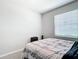 Neutral bedroom with a bed, window with blinds, and a suitcase on the floor at 5233 Nw 43Rd Lane Rd, Ocala, FL 34482