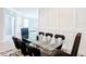 A well-lit dining area features glass-top table, plush black chairs, and stylish decor at 5233 Nw 43Rd Lane Rd, Ocala, FL 34482