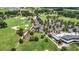 Aerial view of a well-maintained golf course with lush greenery, sand traps, ponds, and community amenities at 5233 Nw 43Rd Lane Rd, Ocala, FL 34482