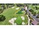 Aerial view showcasing a golf course with sand traps, water features, and manicured greens at 5233 Nw 43Rd Lane Rd, Ocala, FL 34482