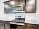 Kitchen featuring stainless steel appliances, granite countertops, and dark wood cabinets at 5233 Nw 43Rd Lane Rd, Ocala, FL 34482