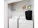 Laundry room featuring a washer, dryer, shelving, and neutral walls at 5233 Nw 43Rd Lane Rd, Ocala, FL 34482