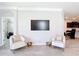 Comfortable living space with contemporary armchairs, modern decor, and sleek tile flooring, adjacent to kitchen at 5233 Nw 43Rd Lane Rd, Ocala, FL 34482