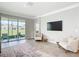 Inviting living room with large sliding doors to the patio, stylish seating, and a modern entertainment setup at 5233 Nw 43Rd Lane Rd, Ocala, FL 34482