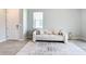 Elegant living room showcasing a plush sofa, decorative rug, and tiled flooring, enhanced by natural light from the window at 5233 Nw 43Rd Lane Rd, Ocala, FL 34482