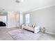 Bright living room with a modern white sofa, decorative rug, and stylish gold accents, enhanced by natural light at 5233 Nw 43Rd Lane Rd, Ocala, FL 34482