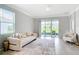 Bright and airy living room with a cozy sofa, stylish decor, and seamless access to the outdoor patio area at 5233 Nw 43Rd Lane Rd, Ocala, FL 34482
