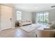 Chic living area with contemporary furniture, neutral colors, and direct access to the backyard through sliding glass doors at 5233 Nw 43Rd Lane Rd, Ocala, FL 34482