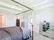 Primary bedroom with a canopy bed, closet, and access to an adjoining room at 5233 Nw 43Rd Lane Rd, Ocala, FL 34482