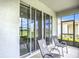 Inviting screened-in patio with seating, offering a seamless transition to outdoor living at 5233 Nw 43Rd Lane Rd, Ocala, FL 34482