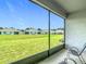 Serene screened-in patio with comfortable seating offering panoramic views of the manicured backyard at 5233 Nw 43Rd Lane Rd, Ocala, FL 34482