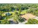 Expansive aerial view showcasing the property's surroundings, including verdant trees and new development area at 5596 Nw 57Th St, Ocala, FL 34482