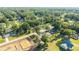 Aerial shot of property in a neighborhood setting, revealing nearby construction and surrounding mature trees at 5596 Nw 57Th St, Ocala, FL 34482