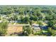 Aerial view displays the property, neighboring homes, surrounding trees, and adjacent construction site in the area at 5596 Nw 57Th St, Ocala, FL 34482