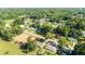 Property aerial view, showcasing its neighborhood location amid mature trees, with adjacent construction site visible at 5596 Nw 57Th St, Ocala, FL 34482