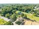 Aerial perspective of the property, illustrating its setting amidst a canopy of trees and nearby construction site at 5596 Nw 57Th St, Ocala, FL 34482