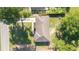 Overhead view of the house showing the roof and the surrounding greenery with a glimpse of the neighborhood street at 5596 Nw 57Th St, Ocala, FL 34482