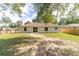 Back exterior view of home with large yard and patio area, great for entertaining at 5596 Nw 57Th St, Ocala, FL 34482