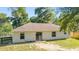 Rear exterior view featuring the back of the house with sliding glass doors leading to the backyard space at 5596 Nw 57Th St, Ocala, FL 34482