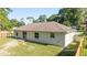 A view of the backyard showing the home's siding, windows, and door for easy access to the outdoors at 5596 Nw 57Th St, Ocala, FL 34482