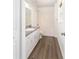 This bright bathroom features a tub/shower combo and wood-look floors at 5596 Nw 57Th St, Ocala, FL 34482
