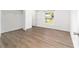 Light-filled bedroom with closet and wood-look flooring and large window at 5596 Nw 57Th St, Ocala, FL 34482