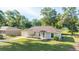 Well-kept single-story home with an attached garage and beautifully landscaped front yard in a tranquil neighborhood at 5596 Nw 57Th St, Ocala, FL 34482