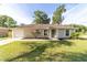 Well-kept home with a lush green lawn, clean walkways, and a neatly manicured front garden at 5596 Nw 57Th St, Ocala, FL 34482