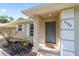 Inviting front porch with a gray front door and landscaping, offering a warm welcome to the home at 5596 Nw 57Th St, Ocala, FL 34482