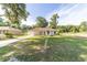 Beautiful home featuring a lush lawn, driveway, and attached garage with a serene neighborhood backdrop at 5596 Nw 57Th St, Ocala, FL 34482