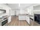 Open kitchen featuring stainless steel appliances, white cabinetry and granite countertops at 5596 Nw 57Th St, Ocala, FL 34482