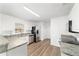 Bright kitchen with white cabinets, stainless steel appliances, and wood-look flooring at 5596 Nw 57Th St, Ocala, FL 34482