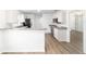 Modern kitchen featuring stainless steel appliances, sleek cabinetry, and a breakfast bar overlooking the living area at 5596 Nw 57Th St, Ocala, FL 34482