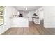 Modern kitchen features white cabinetry, stainless steel appliances, and a breakfast bar overlooking the living area at 5596 Nw 57Th St, Ocala, FL 34482