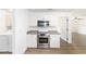 Efficient kitchen with modern stainless steel appliances, white cabinets, and durable countertops at 5596 Nw 57Th St, Ocala, FL 34482