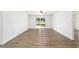Spacious living room with wood-look floors and access to outdoor area at 5596 Nw 57Th St, Ocala, FL 34482