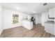 Bright, airy living space with modern flooring, a breakfast bar, and sleek, modern appliances at 5596 Nw 57Th St, Ocala, FL 34482