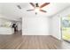 Spacious room featuring an open floor plan, wood-look flooring and a ceiling fan at 5596 Nw 57Th St, Ocala, FL 34482