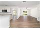 Open floor plan with living area featuring wood-look flooring and natural light at 5596 Nw 57Th St, Ocala, FL 34482