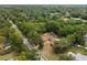 Home's aerial view highlighting a private pool, backyard, and surrounding tree coverage at 581 Ne 44Th Ave, Ocala, FL 34470