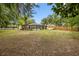 Expansive backyard featuring a screened-in pool, mature trees, and plenty of open space at 581 Ne 44Th Ave, Ocala, FL 34470