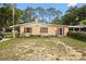Charming single-story home with red shutters and well-manicured front yard at 581 Ne 44Th Ave, Ocala, FL 34470