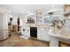 Well-lit kitchen featuring granite countertops, white cabinetry, and a stainless steel refrigerator at 581 Ne 44Th Ave, Ocala, FL 34470