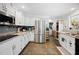 Modern kitchen with stainless steel appliances, white cabinets, and granite counters offering style and functionality at 581 Ne 44Th Ave, Ocala, FL 34470