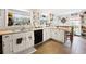 Bright eat-in kitchen boasts white cabinets, granite countertops, and tiled floors at 581 Ne 44Th Ave, Ocala, FL 34470