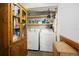 Spacious laundry room with shelving, washer, dryer, and storage cabinet at 581 Ne 44Th Ave, Ocala, FL 34470