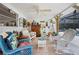 Cozy sunroom with wicker furniture and tiled floors, perfect for relaxation at 581 Ne 44Th Ave, Ocala, FL 34470