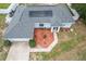 Aerial view of a home with solar panels, landscaping, and a driveway, highlighting the property's layout at 603 Marion Oaks Blvd, Ocala, FL 34473